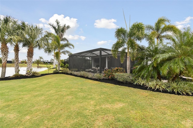 view of yard featuring a lanai and a water view