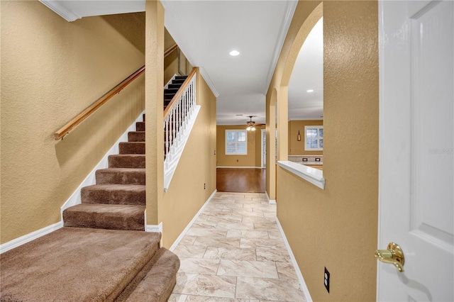 entryway featuring ceiling fan and ornamental molding