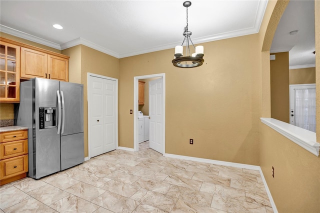 kitchen with stainless steel fridge with ice dispenser, light stone counters, ornamental molding, and separate washer and dryer