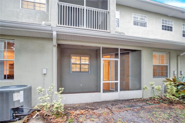 exterior space with a sunroom and central air condition unit