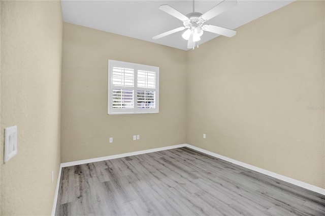 spare room with ceiling fan and light wood-type flooring