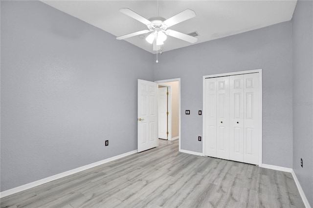 unfurnished bedroom featuring light wood-type flooring, a closet, and ceiling fan