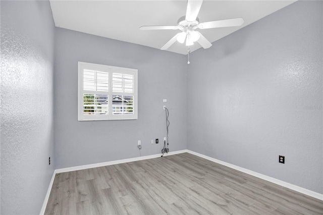 spare room featuring ceiling fan and light wood-type flooring