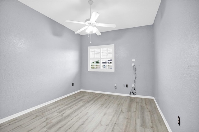 empty room with light hardwood / wood-style floors and ceiling fan