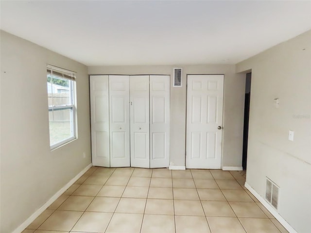 unfurnished bedroom featuring light tile patterned floors