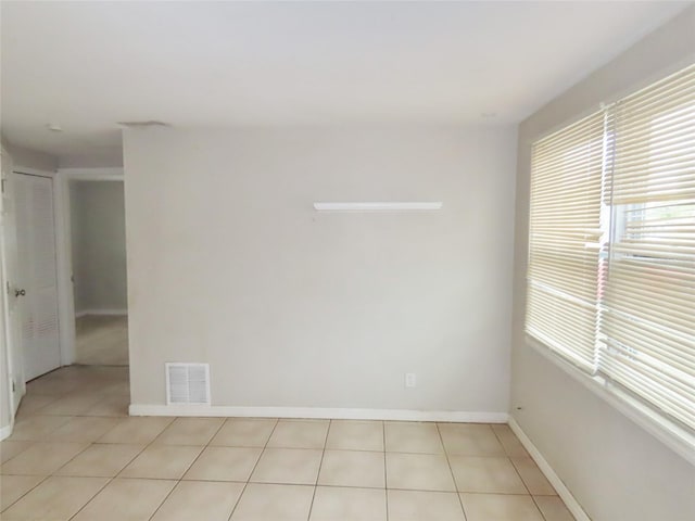 tiled spare room featuring a wealth of natural light