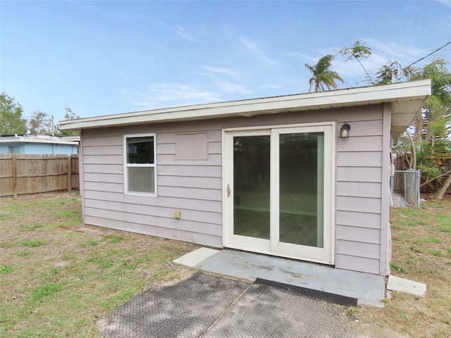 rear view of house with a yard and an outdoor structure