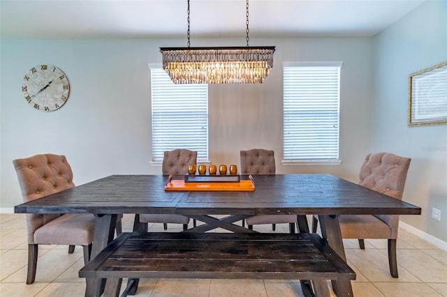 dining space with a chandelier, a healthy amount of sunlight, and tile patterned floors