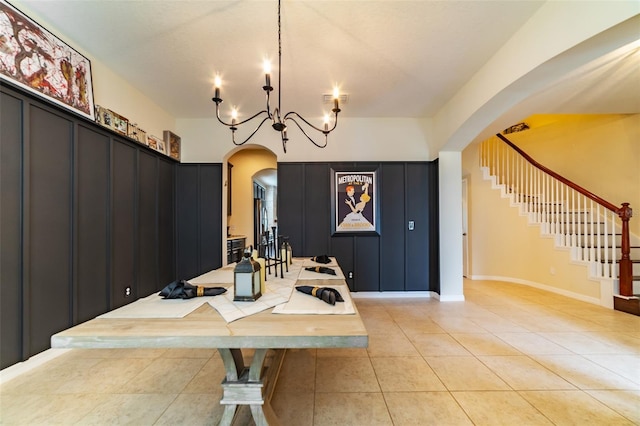 dining space with light tile patterned flooring and a chandelier