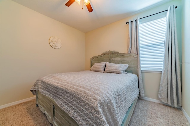 bedroom featuring ceiling fan, light colored carpet, and multiple windows