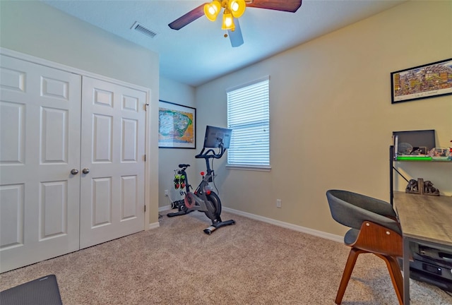 exercise room featuring light colored carpet and ceiling fan