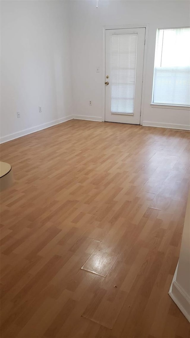 spare room with light hardwood / wood-style floors