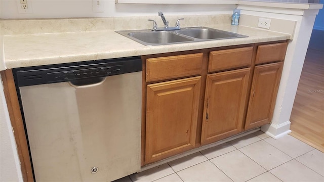 kitchen with sink, dishwasher, and light tile patterned flooring