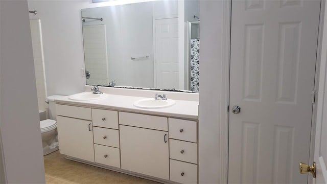 bathroom with toilet, a shower, and vanity