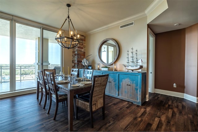 dining area featuring dark wood-type flooring, crown molding, and a notable chandelier