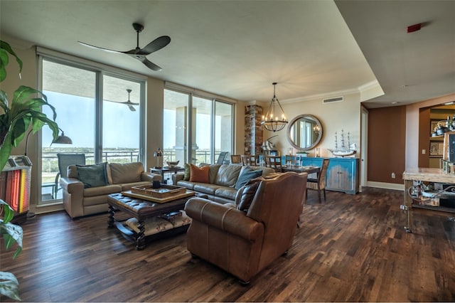 living room featuring ornamental molding, dark hardwood / wood-style flooring, and ceiling fan with notable chandelier