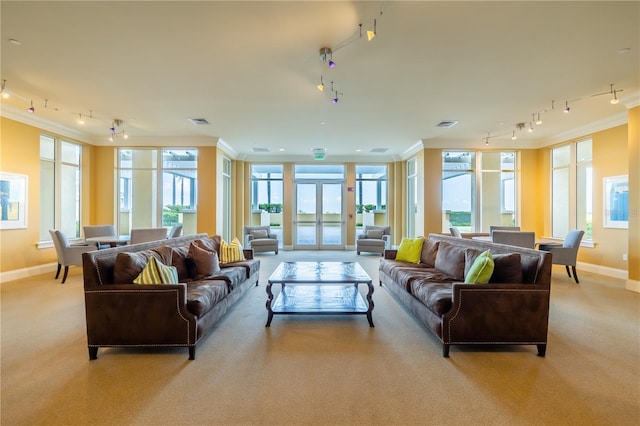 carpeted living room with crown molding and french doors