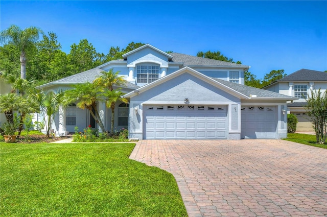 view of front facade with a front yard and a garage