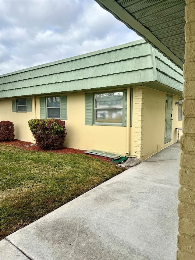 view of side of home featuring a yard