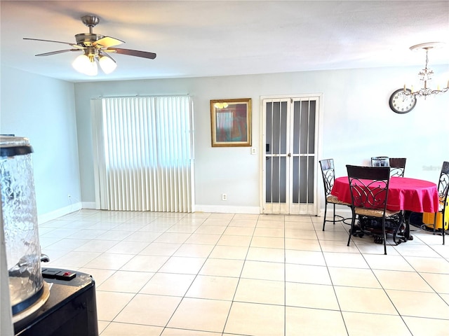 dining space with light tile patterned flooring and ceiling fan with notable chandelier