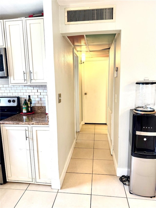 hallway with light tile patterned floors