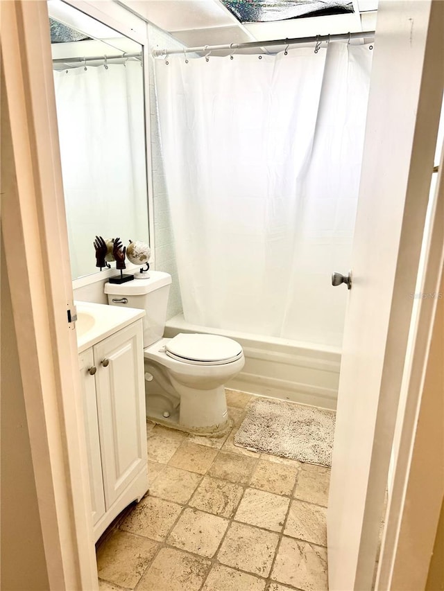 full bathroom with vanity, shower / tub combo, and toilet