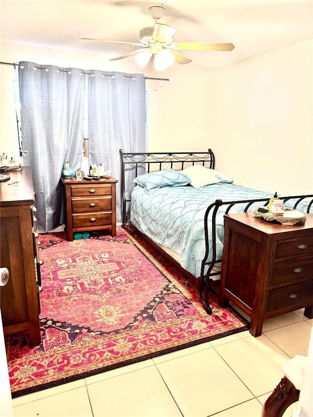 bedroom featuring ceiling fan and tile patterned floors