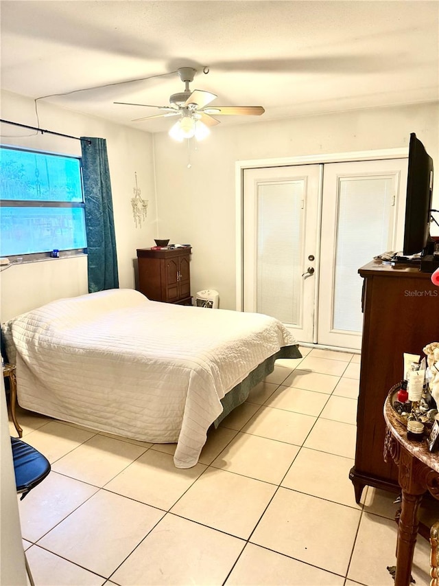 tiled bedroom with ceiling fan