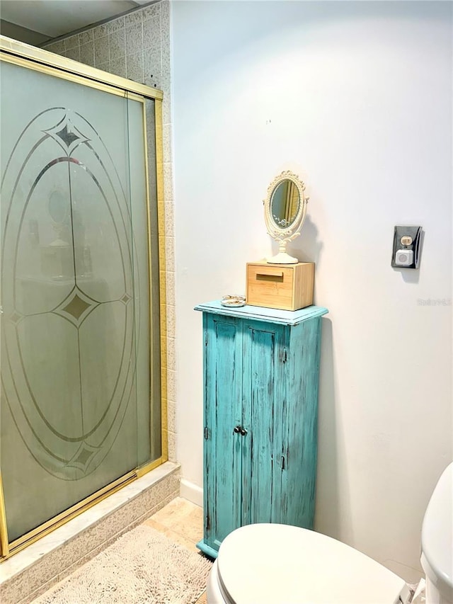 bathroom with an enclosed shower and toilet