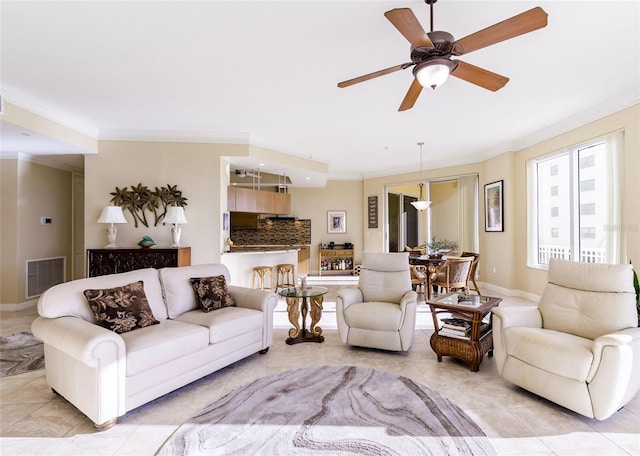 tiled living room featuring ceiling fan and crown molding