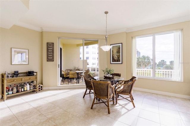 tiled dining room featuring crown molding