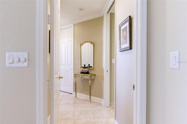 corridor featuring crown molding and light tile patterned flooring