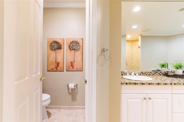 bathroom featuring vanity, toilet, crown molding, and a shower with shower door