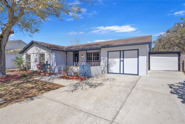 ranch-style home with concrete driveway, a porch, an attached garage, and stucco siding