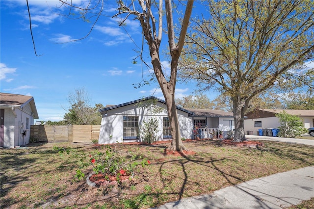 view of front of home featuring fence