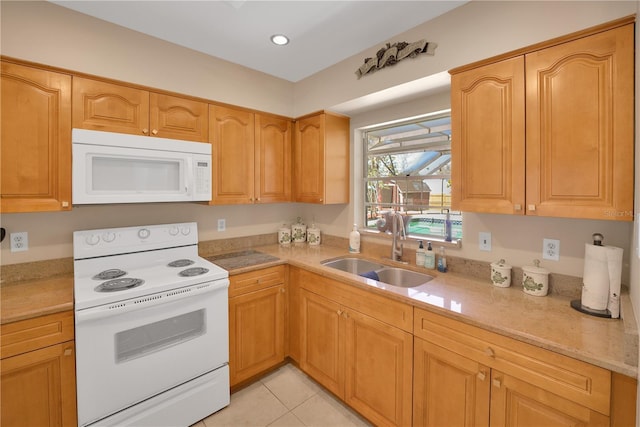 kitchen featuring light stone counters, white appliances, a sink, and light tile patterned floors