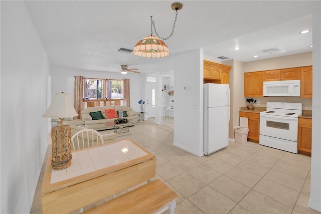 kitchen featuring white appliances, light tile patterned floors, visible vents, open floor plan, and recessed lighting