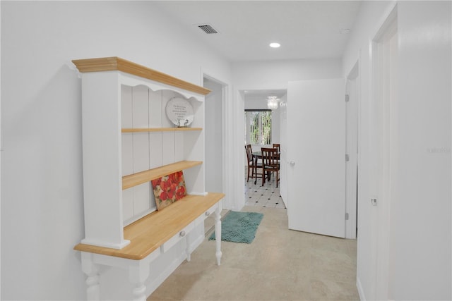 hallway featuring recessed lighting, visible vents, and light floors