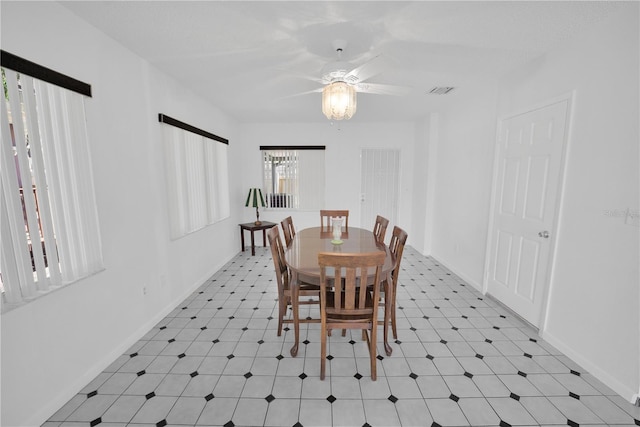 dining space featuring visible vents, baseboards, a ceiling fan, and tile patterned floors