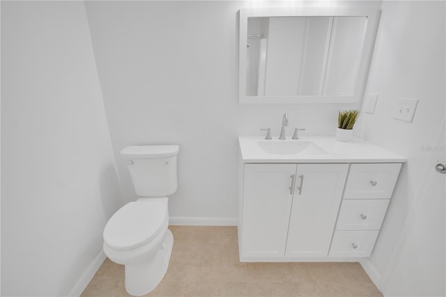 bathroom with tile patterned flooring, baseboards, vanity, and toilet