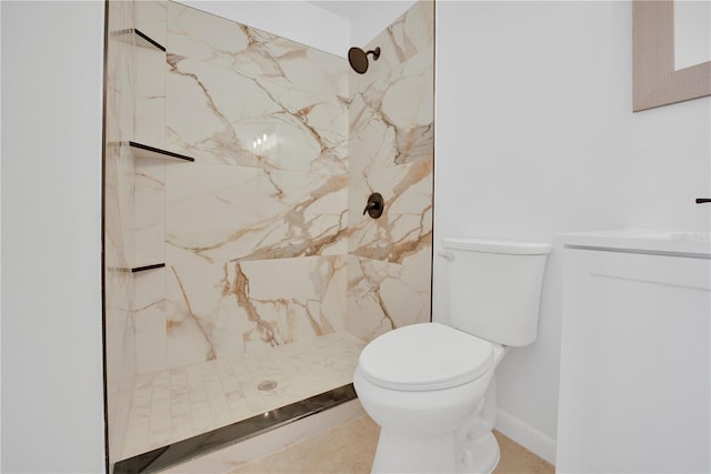 bathroom with toilet, a marble finish shower, and vanity