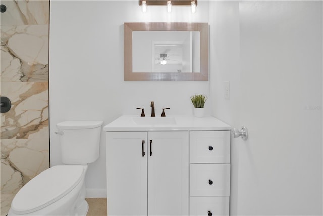 bathroom with toilet, a marble finish shower, and vanity