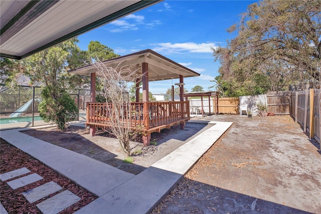 view of patio / terrace featuring a fenced backyard, a wooden deck, and a fenced in pool