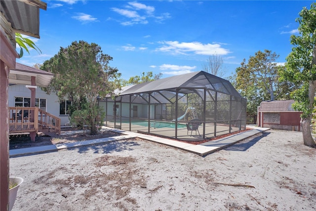 exterior space with a lanai, a patio area, and an outdoor pool