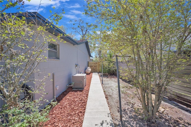 view of side of property featuring fence