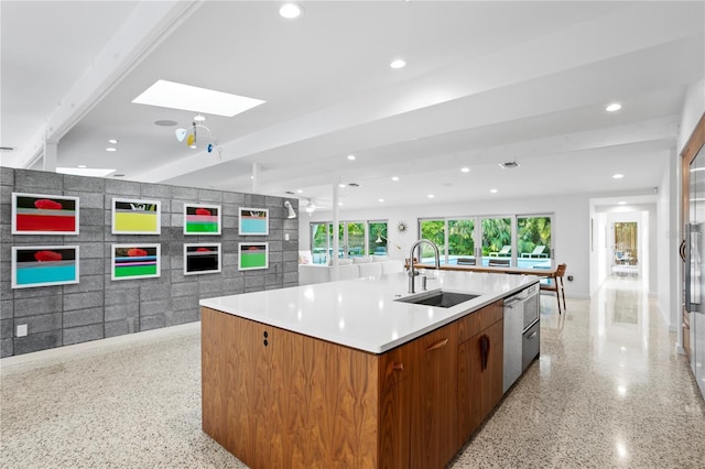 kitchen with dishwasher, a large island, sink, and a skylight