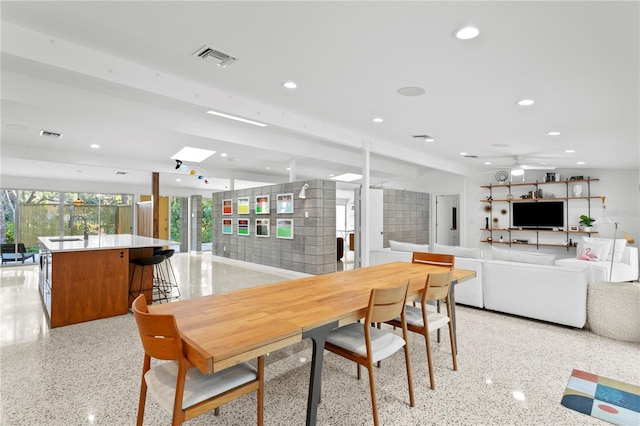 dining space with sink and ceiling fan