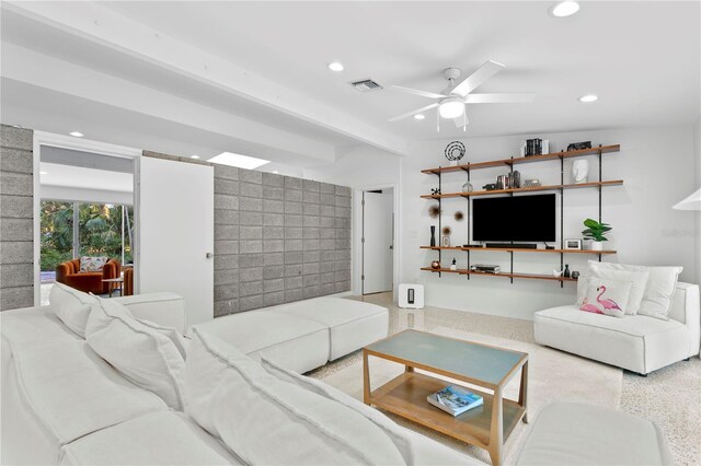 living room featuring ceiling fan and lofted ceiling with beams