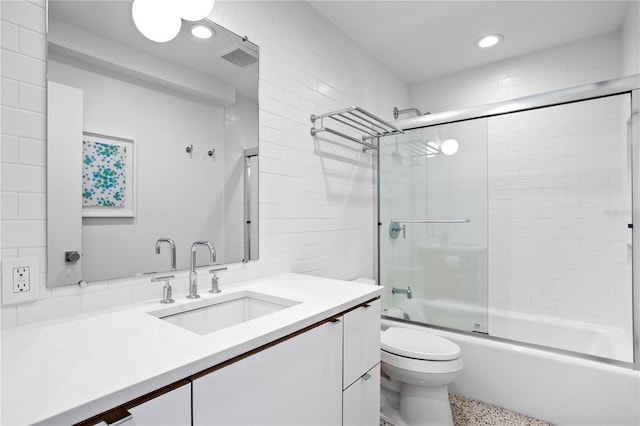 full bathroom with vanity, combined bath / shower with glass door, and toilet