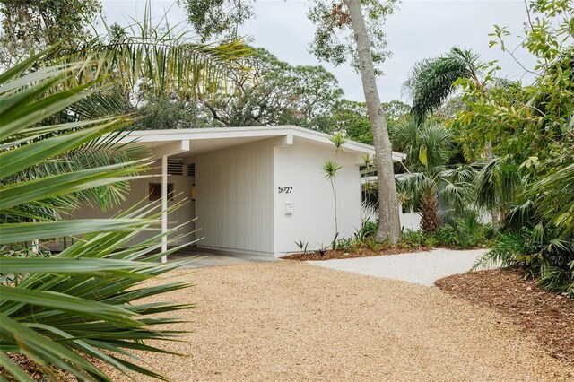 view of side of property with a carport